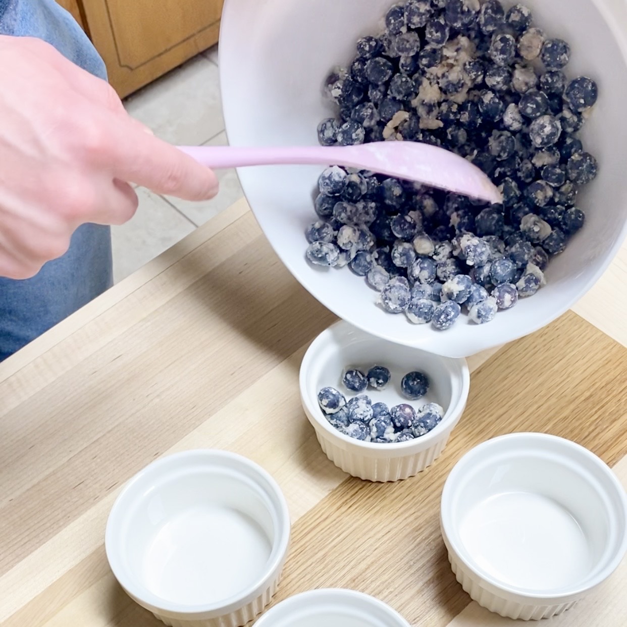 Blueberry cobbler in a ramekin, topped with ice cream