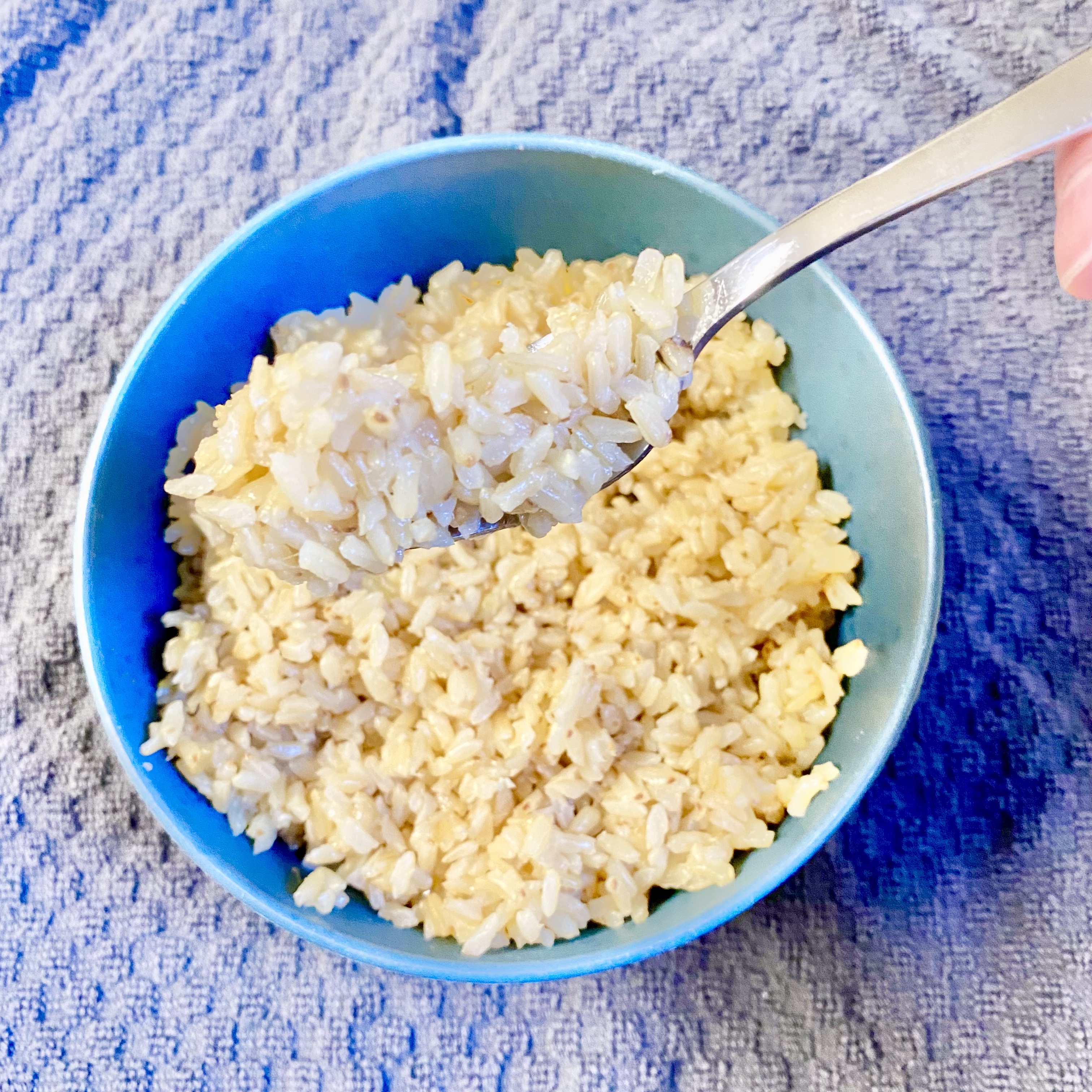 brown rice in a bowl with a fork