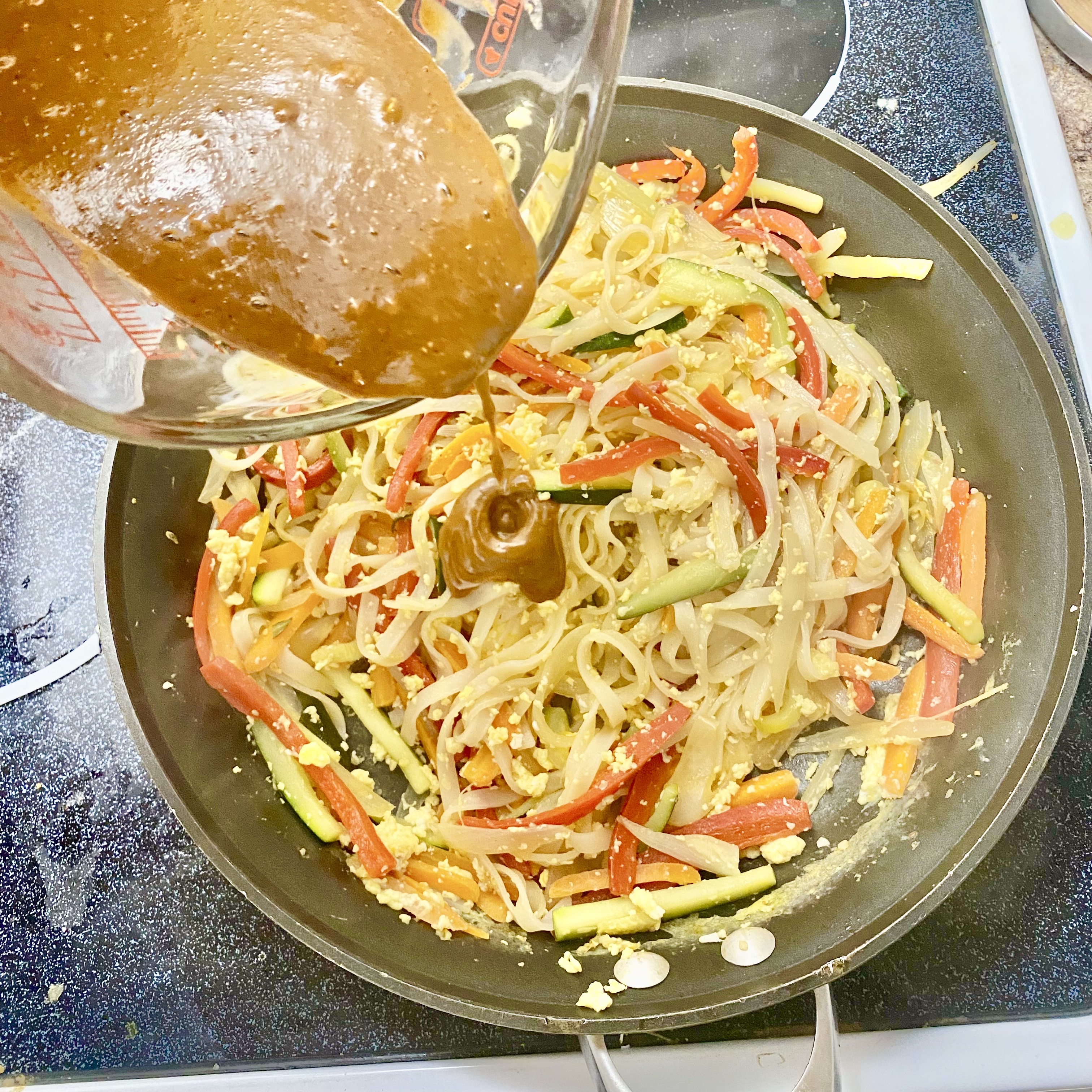 tofu pad Thai topped with broccoli sprouts