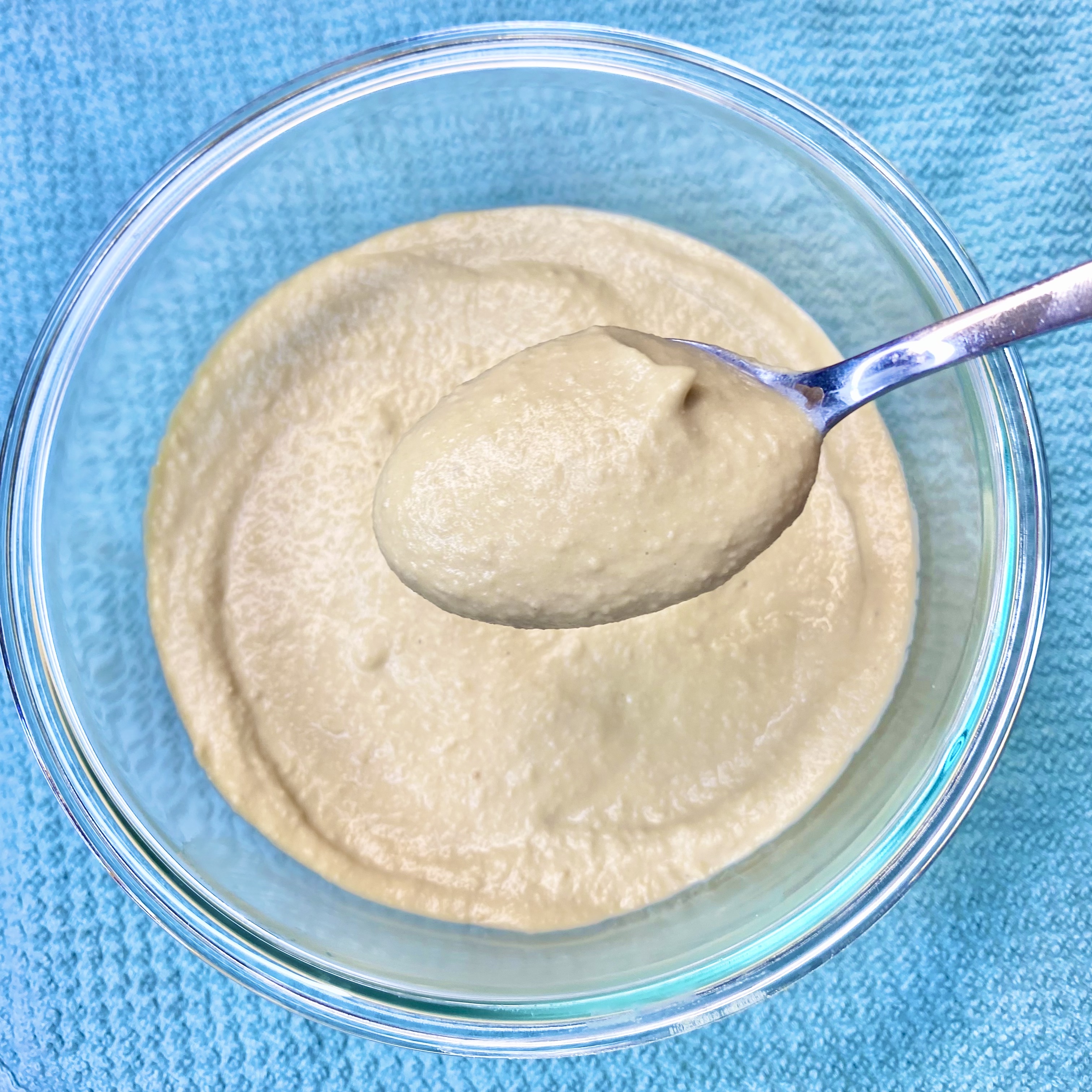 Bowl of hummus topped with parsley