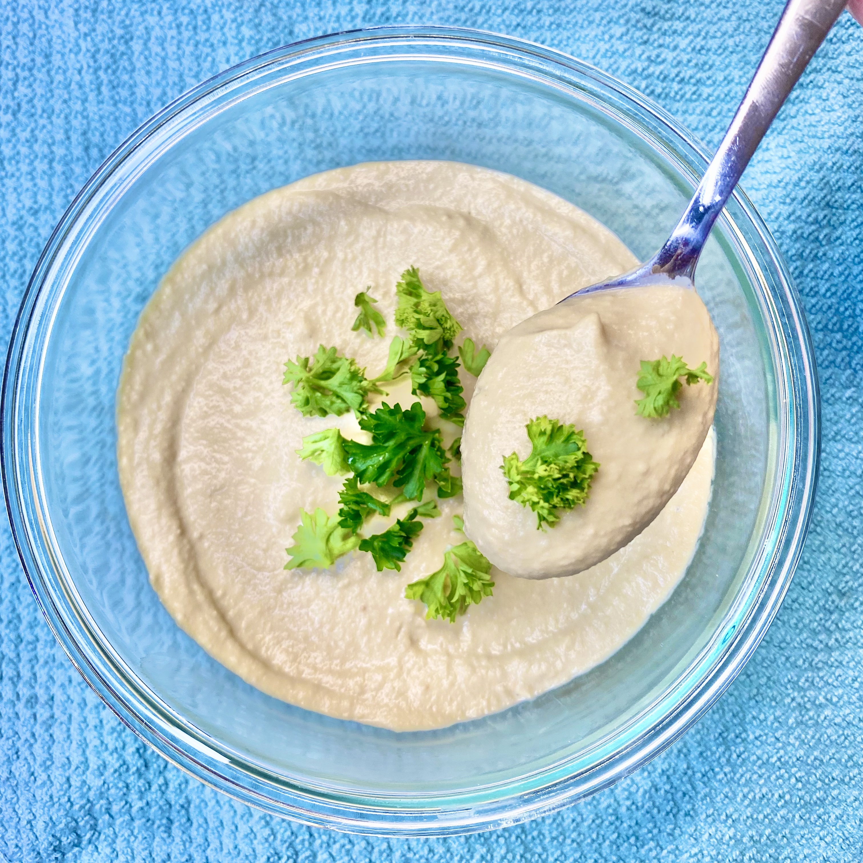 Bowl of hummus topped with parsley