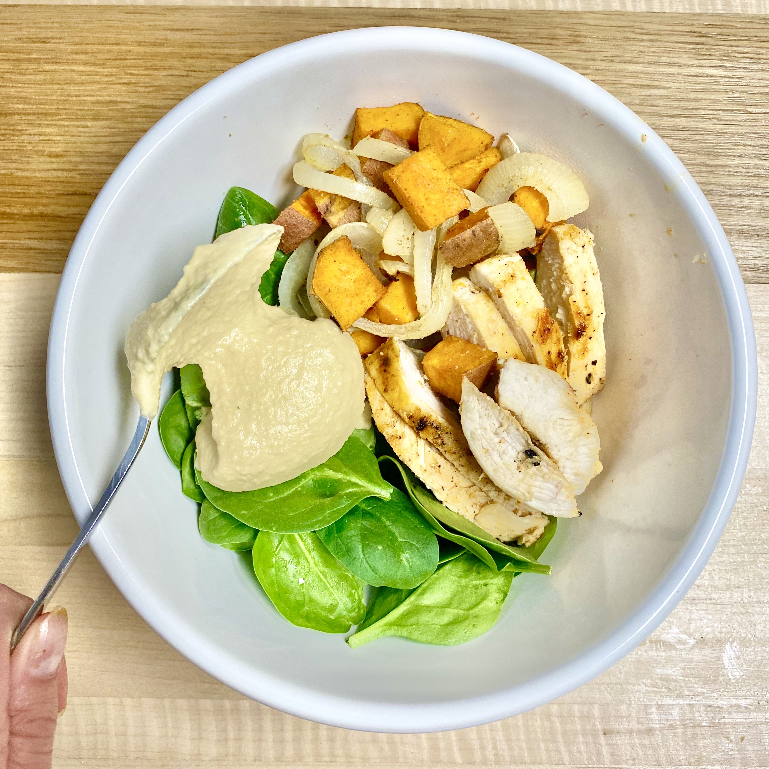 Bowl of hummus topped with parsley