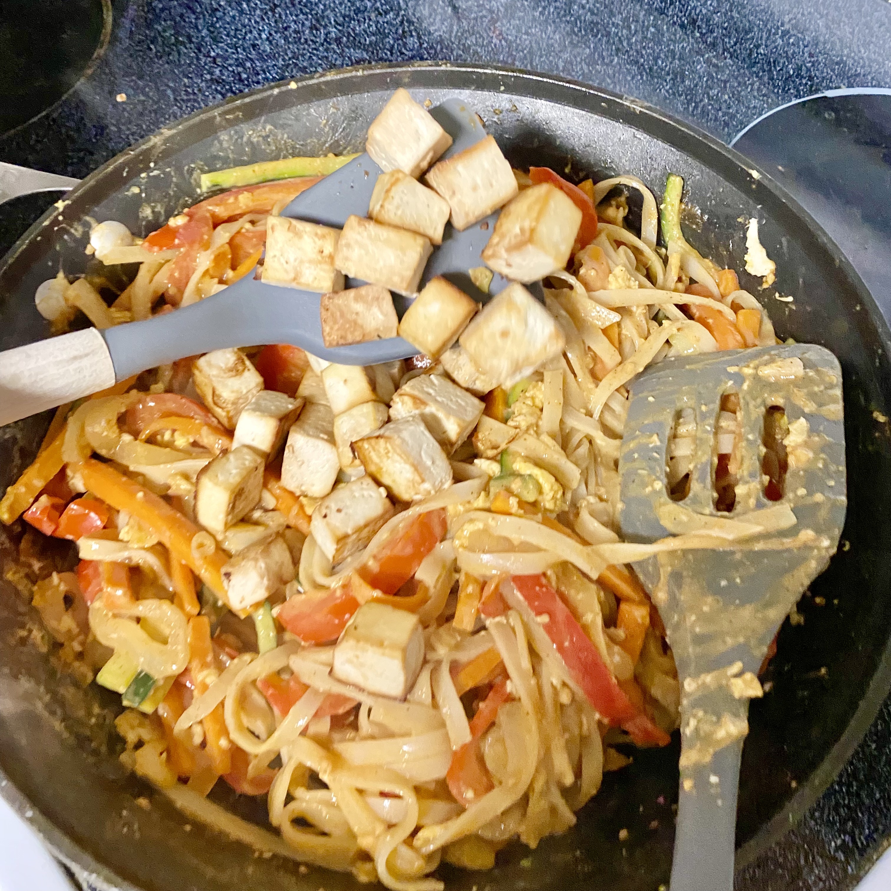 tofu pad Thai topped with broccoli sprouts