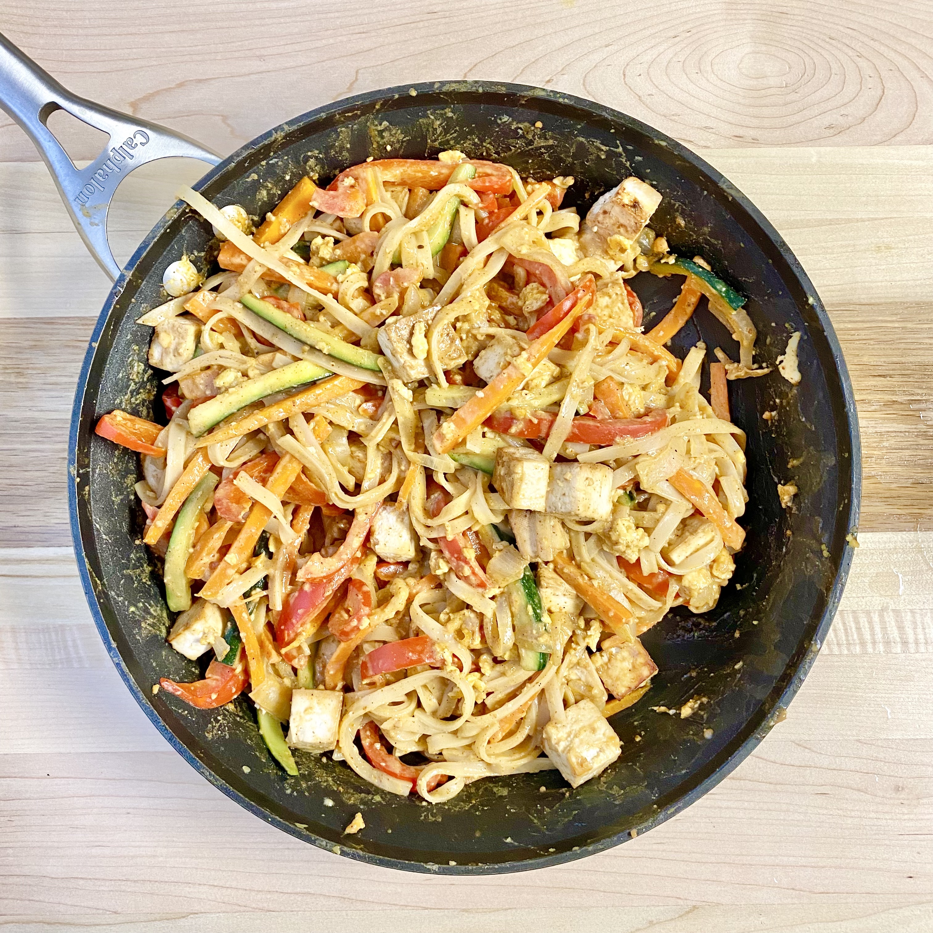 tofu pad Thai topped with broccoli sprouts