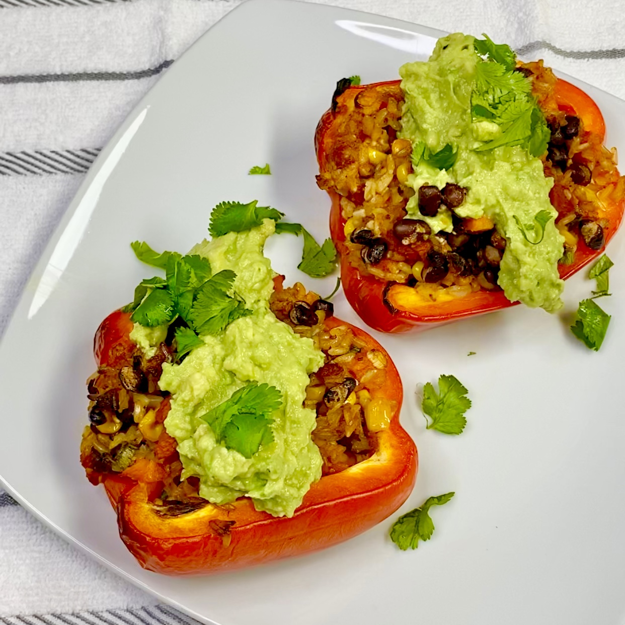 Two stuffed bell peppers with guacamole